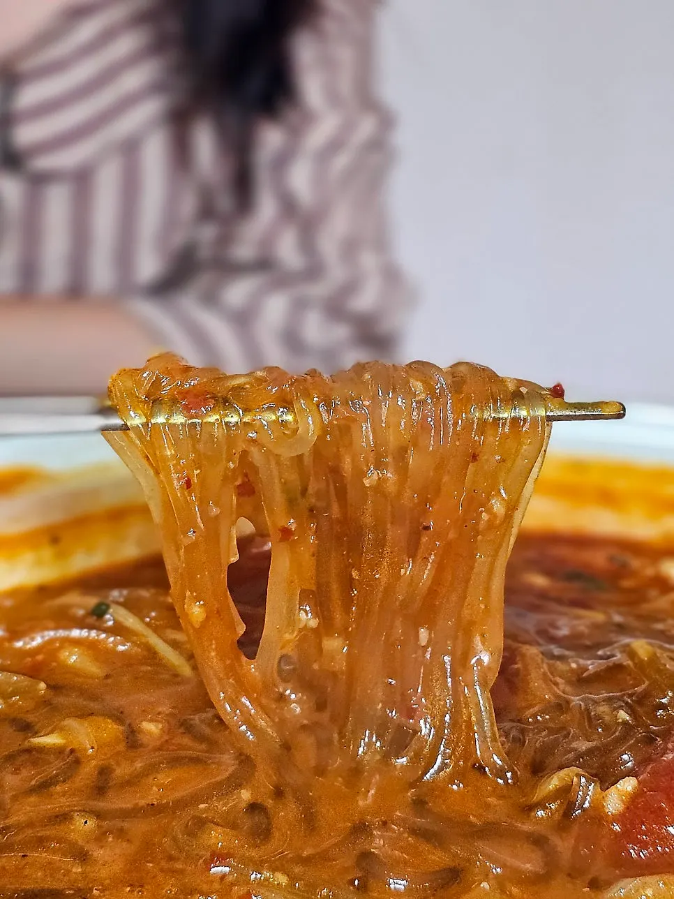 Boneless chicken and glass noodles lifted from the pot