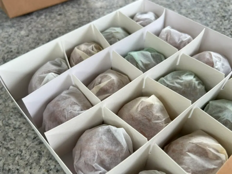 Individually wrapped walnut pastries in different colors by flavor