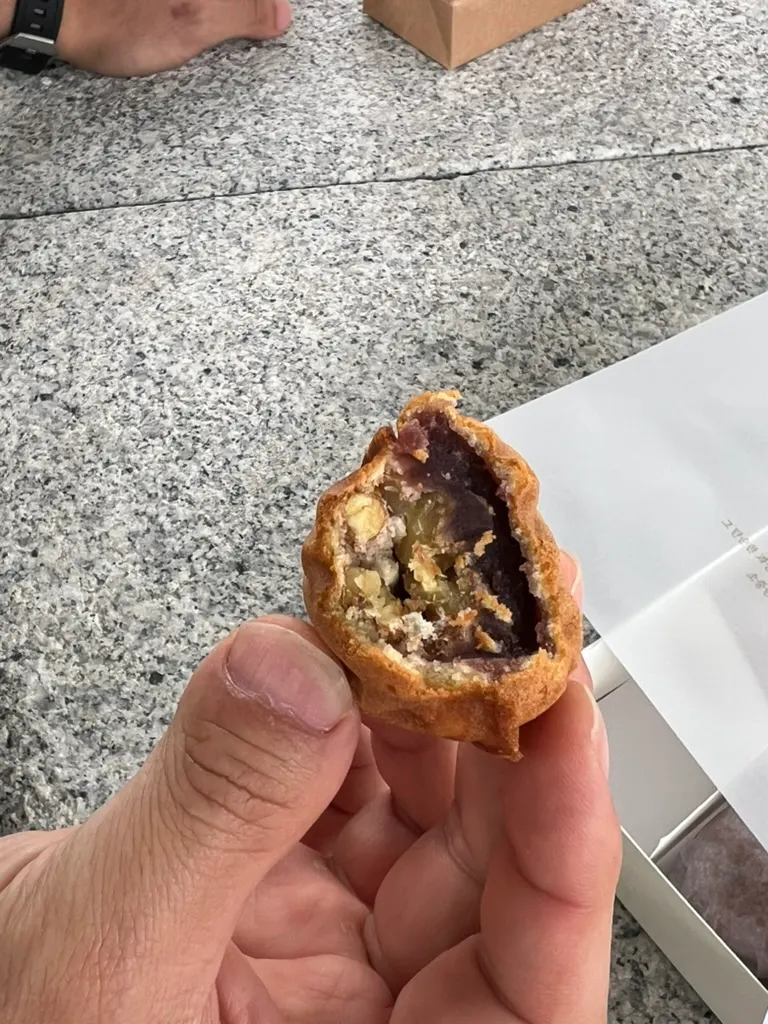 A single walnut pastry unwrapped from its individual packaging