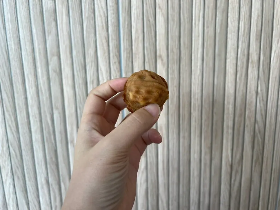Cross-section of a walnut pastry showing the whole walnut inside