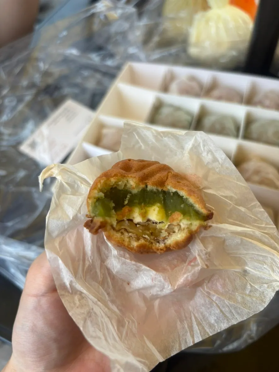 Tasting the walnut pastries at the outdoor table in front of the shop