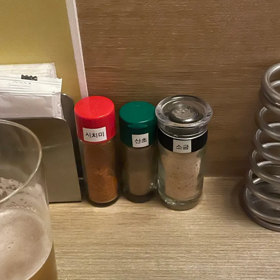 Bowls of shichimi, sansho pepper, and salt