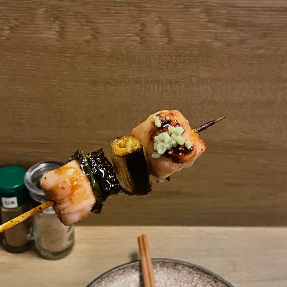 A glass of draft beer with yakitori