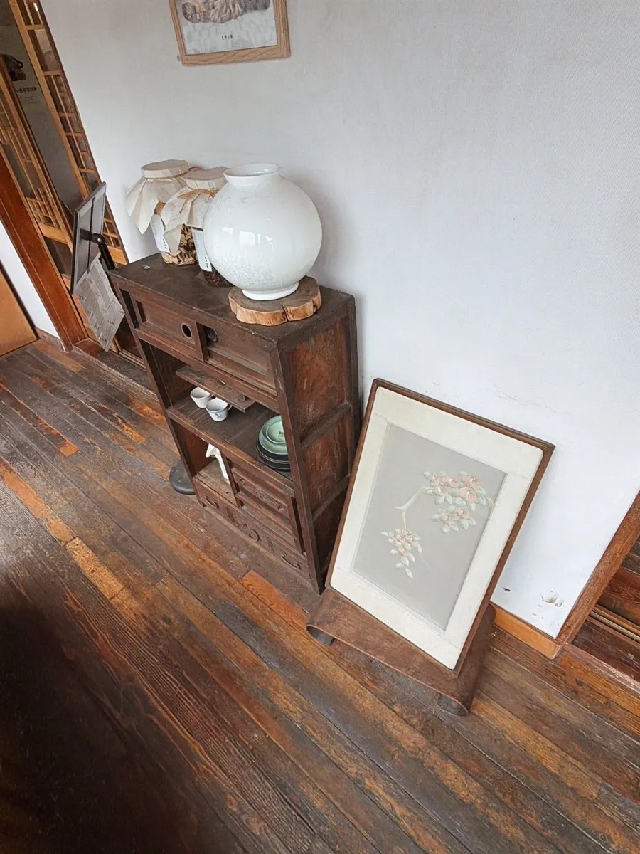A tiger folk painting and an old cabinet as decor pieces