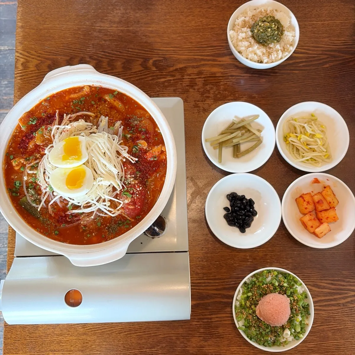 A table set with special chicken stew and two kinds of rice