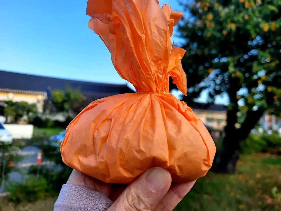 Mango mochi wrapped in orange hanji