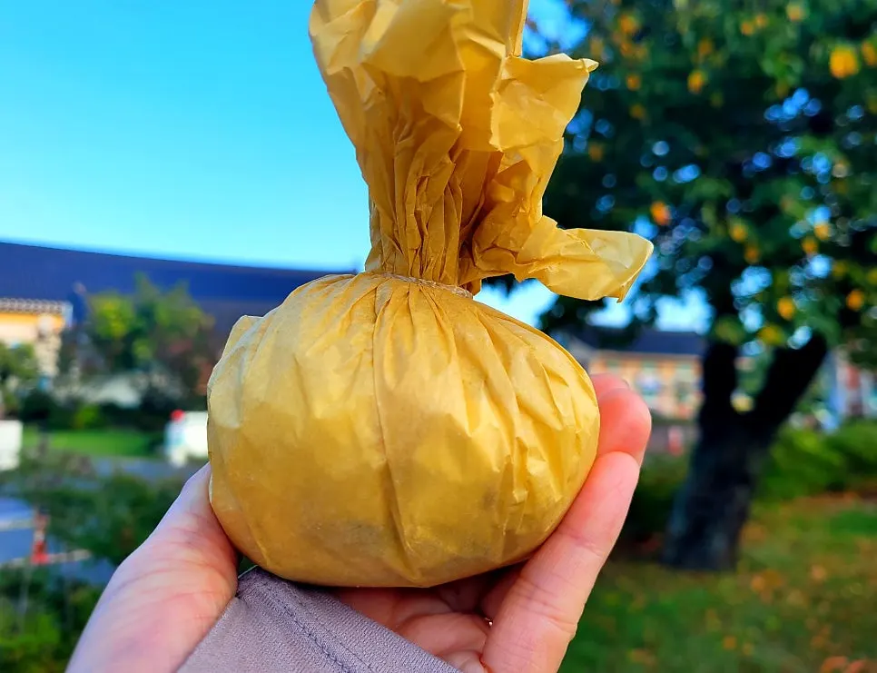 Gold kiwi mochi in hanji wrapping resembling gold kiwi color