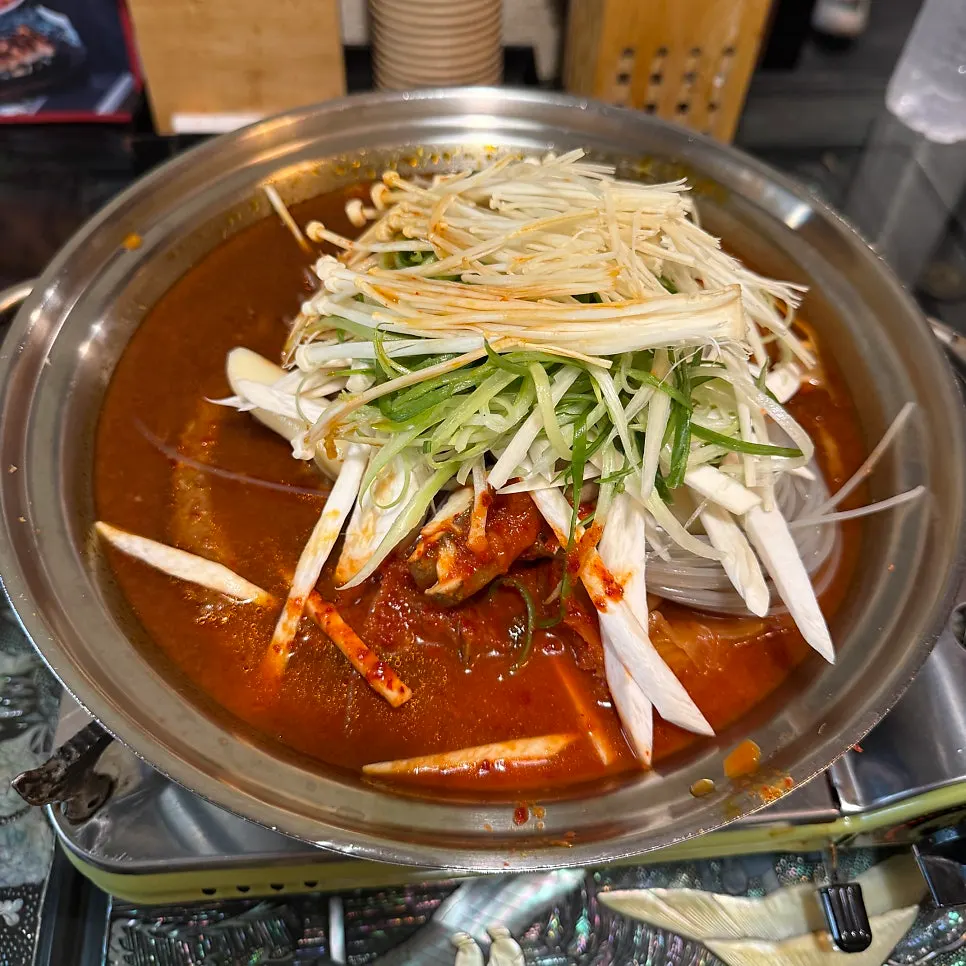 Table spread with the ordered aged kimchi rib stew and yukhoe mulhoe