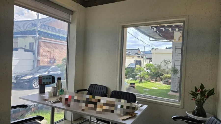 Sunlight streaming into Midam Kitchen's main hall through floor-to-ceiling windows
