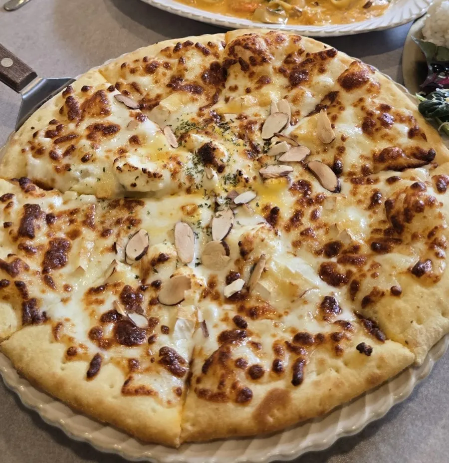 Quattro cheese pizza piled high with cheese