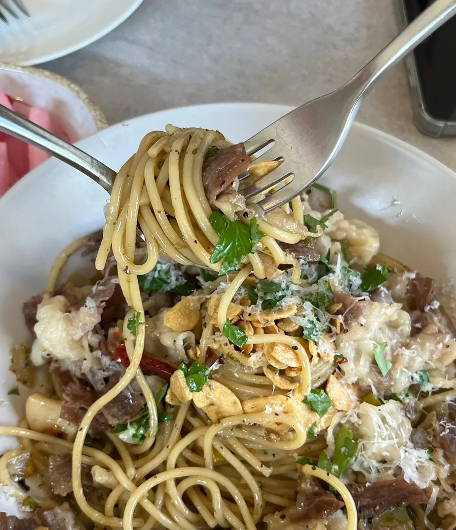 Noodles twirled together with beef brisket