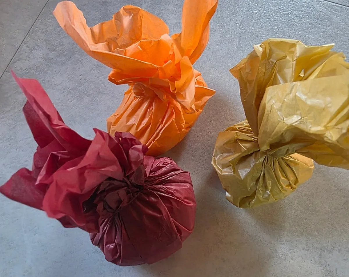 Three Tareudang fruit mochi in differently colored wrapping