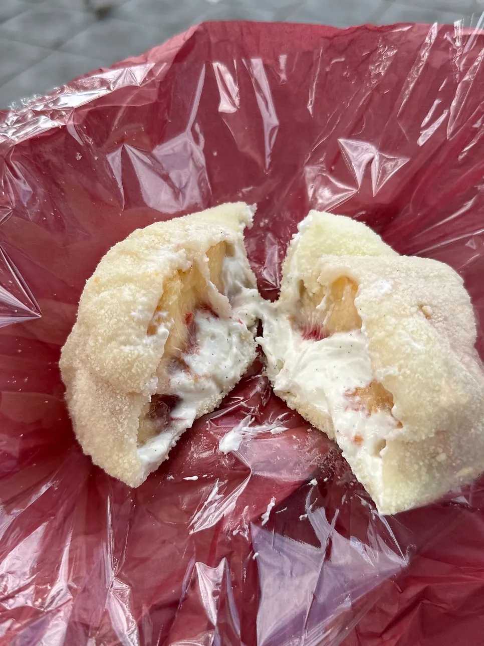 Cross-section of peach yogurt mochi cut with a spoon