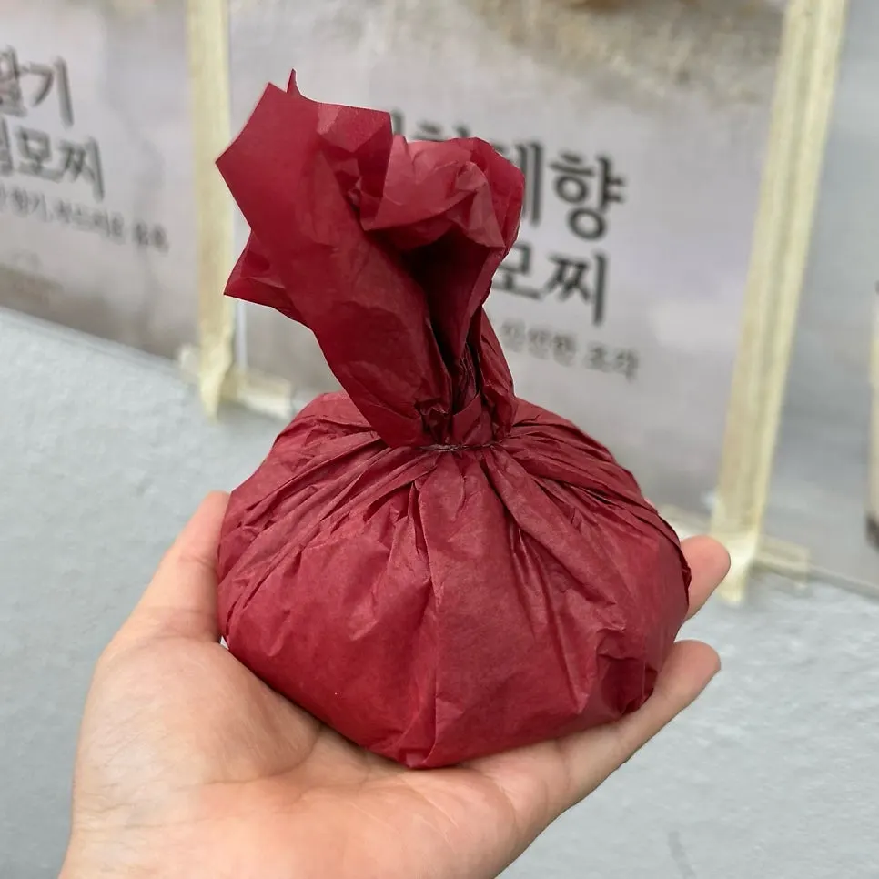 Giant fruit mochi held in hand to show its size