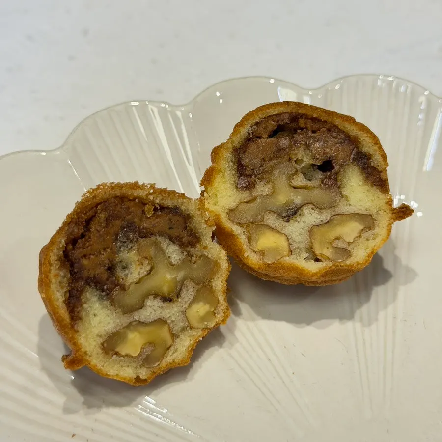Cross-section of a walnut pastry packed with walnuts and paste