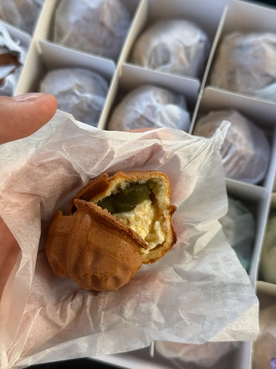 Three flavors of walnut pastry lined up in the box