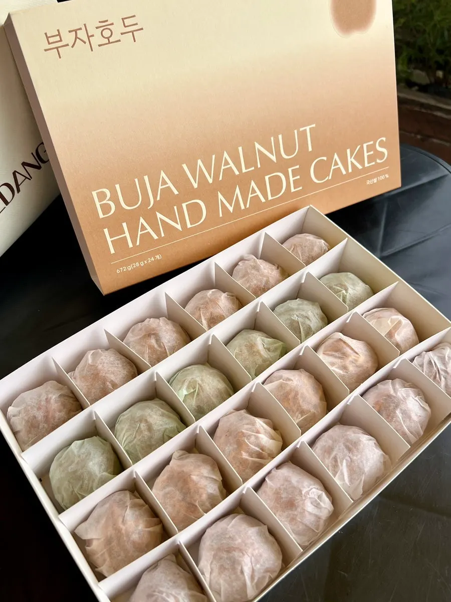 Buja Hodu walnut pastry held in a hand for size comparison
