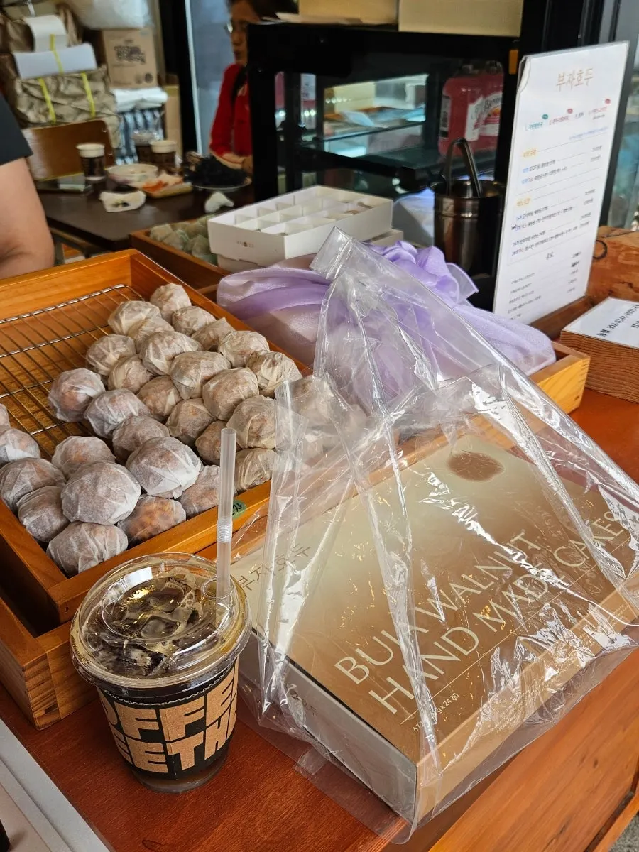 Customers waiting for walnut pastries to be packed at Buja Hodu