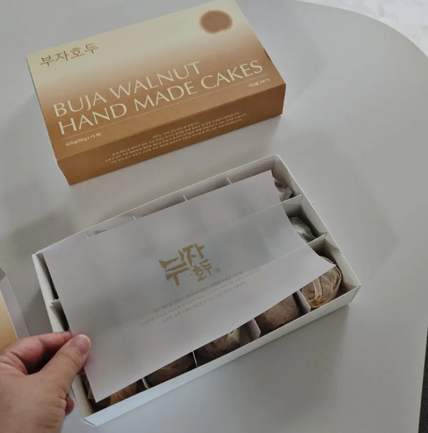 Opening a walnut pastry box lined with wax paper