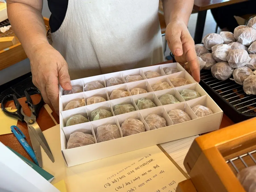 Sign listing the four flavors: low-sugar red bean, pea cream cheese, matcha, and almond praline