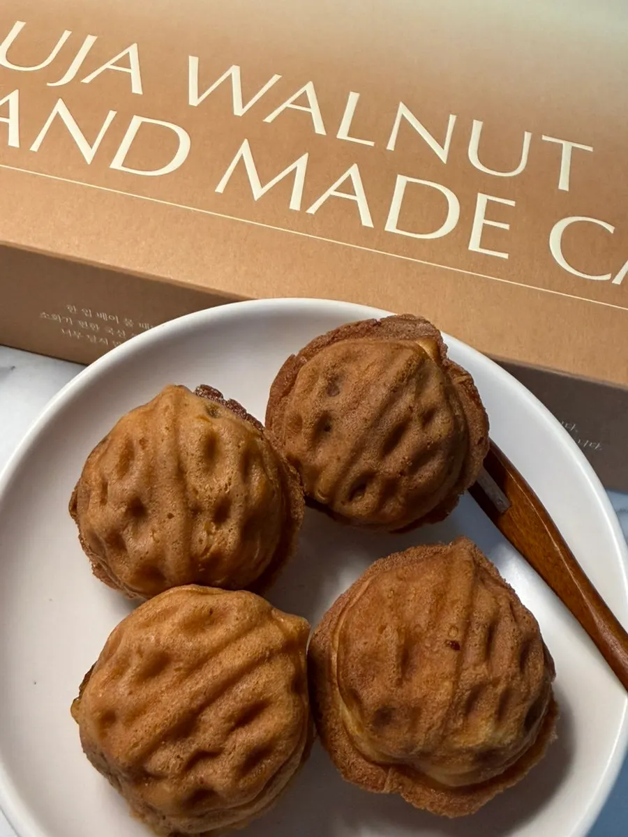 Large walnut pastry held in hand