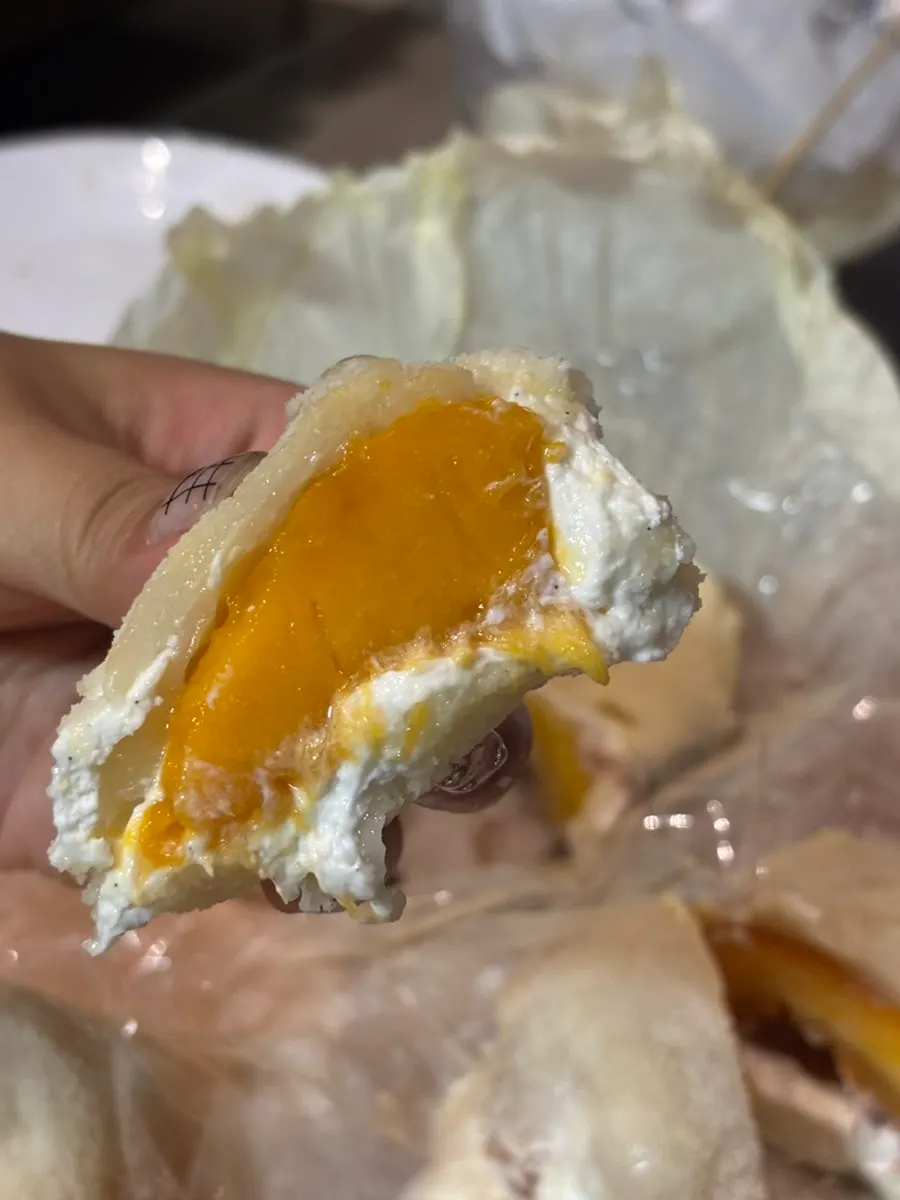 Cross-section of a peach yogurt mochi cut in half