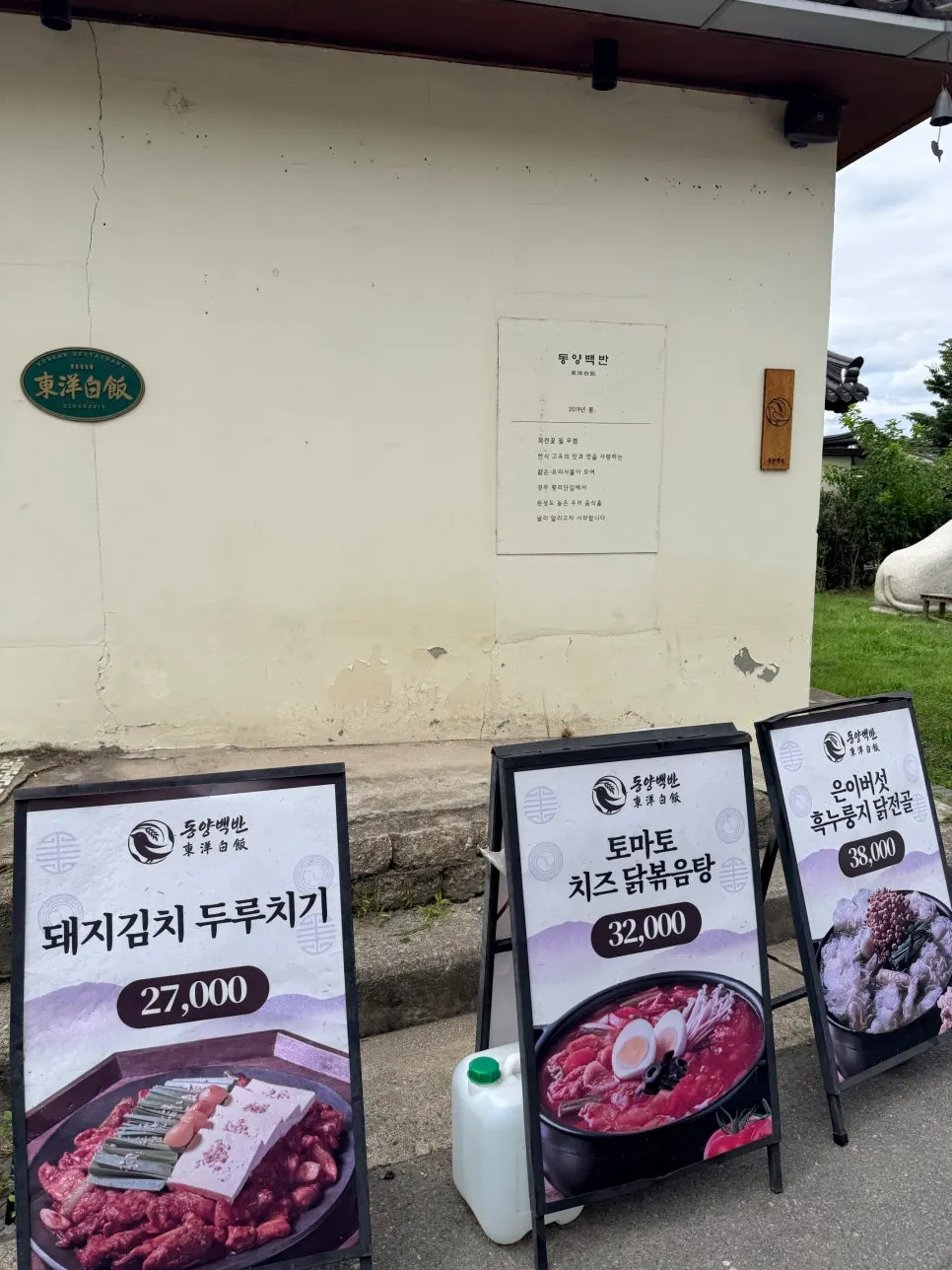기와지붕과 나무 간판이 보이는 한옥 외관