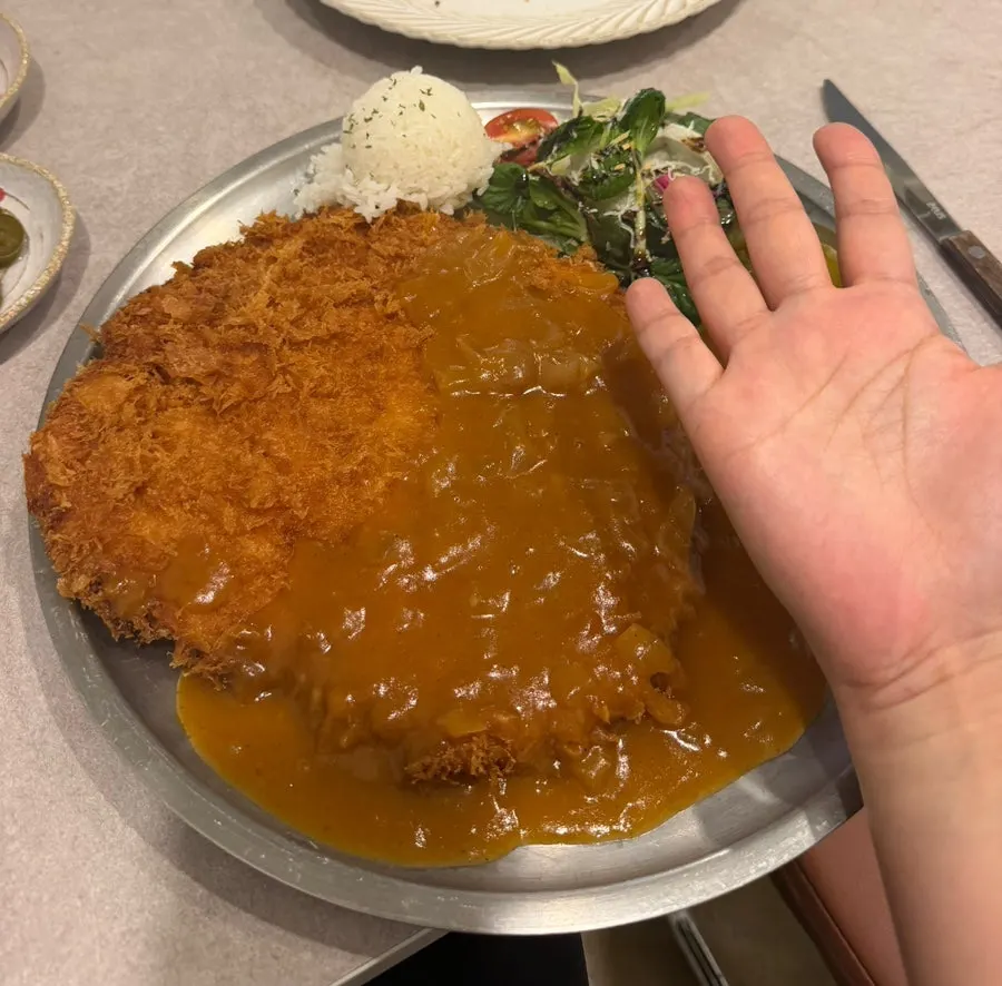 Giant pork loin cutlet filling the plate