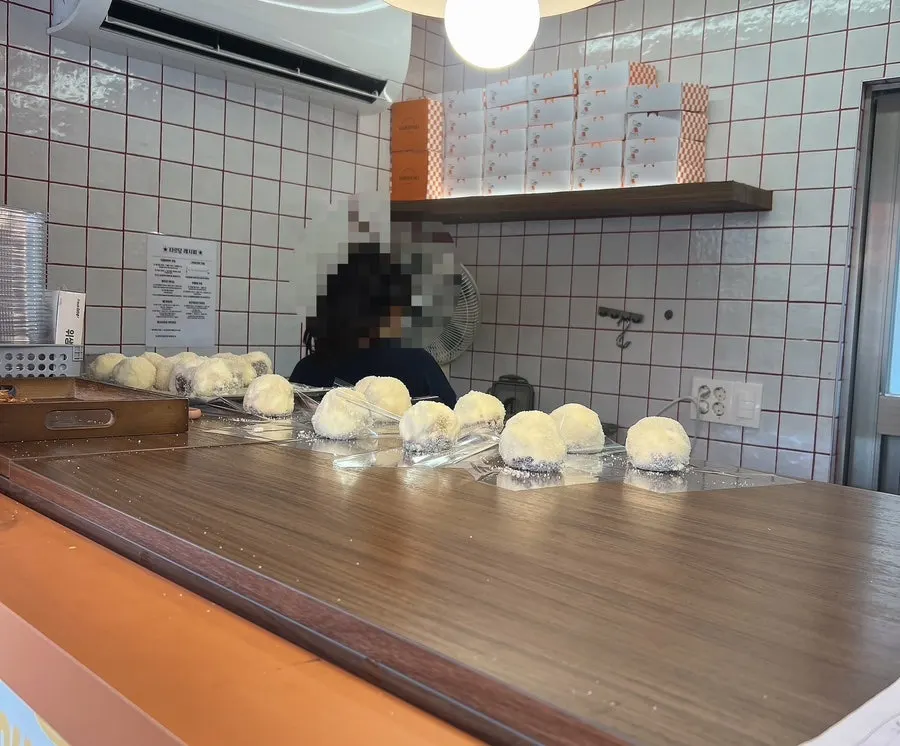 Round fresh fruit mochi arranged in the display case