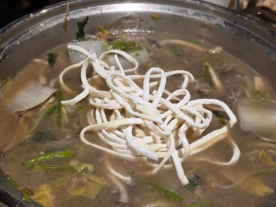 Beef shabu-shabu added to the hot pot