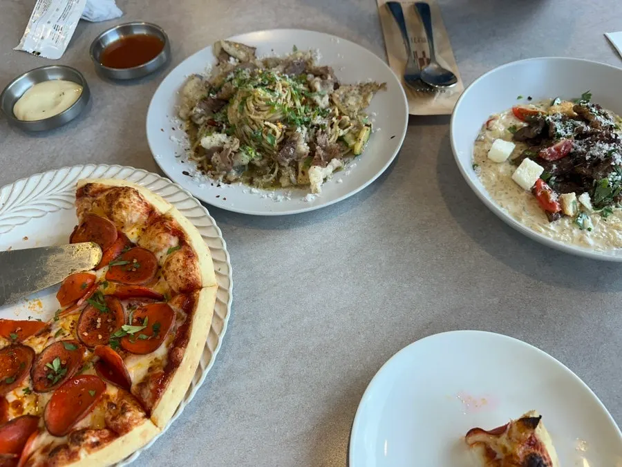 Pizza, pasta, and risotto filling the table