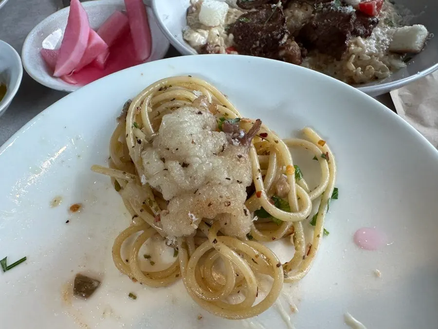 Oil pasta topped with beef brisket and other toppings