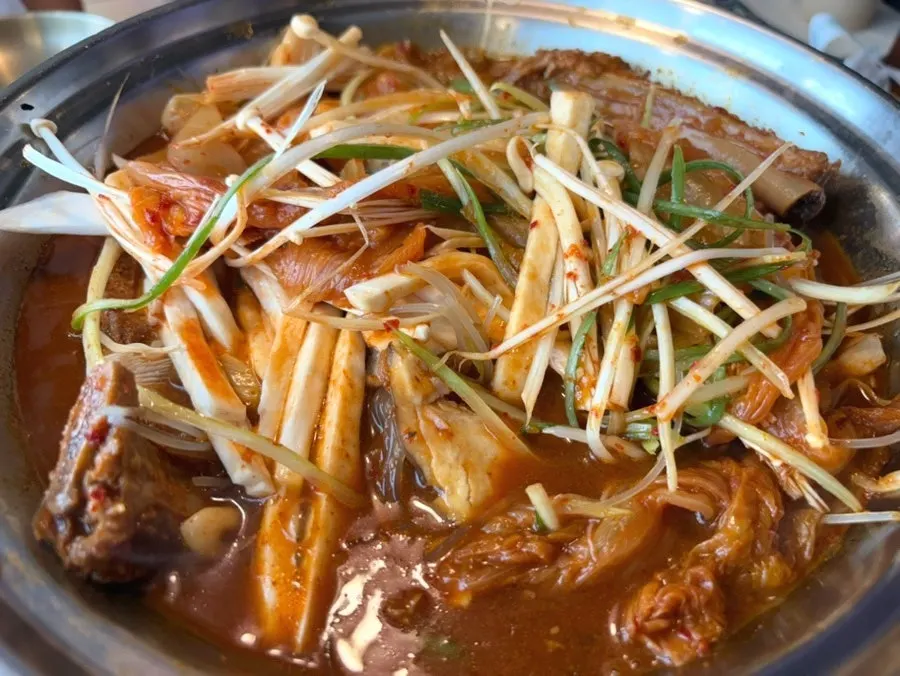 Aged kimchi pork back-rib stew on a gas burner