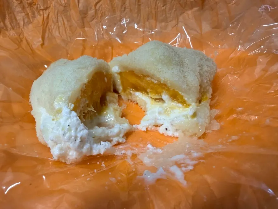 Cross-section of mochi showing a big chunk of mango