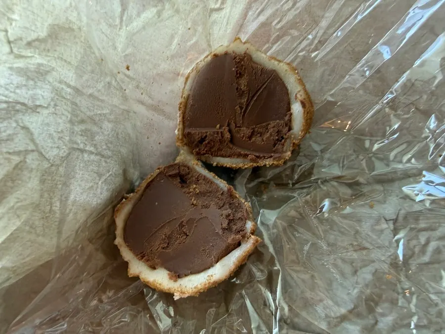 Kiwi mochi on a plate showing the cream inside