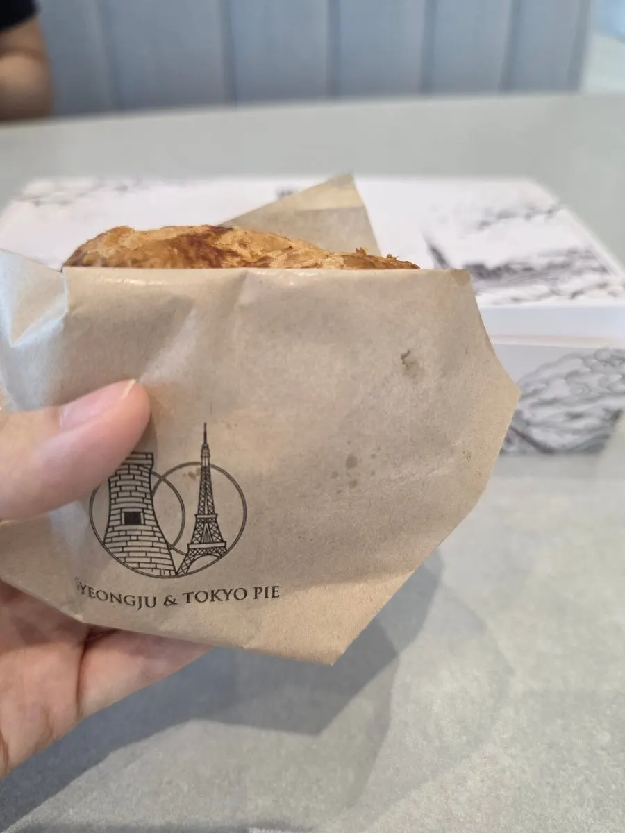 A bite taken out of an apple pie held in hand