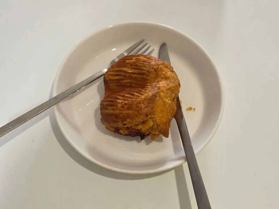 A bite of the apple pie showing its crisp pastry