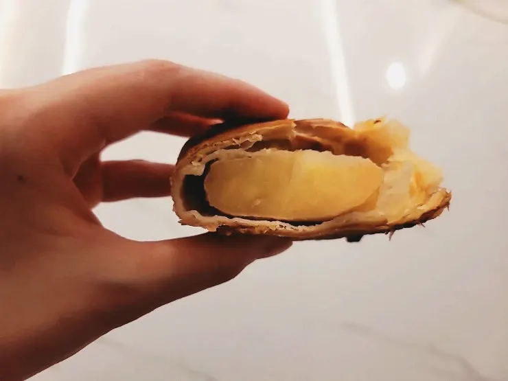 Cross-section of the apple pie packed with whole apple