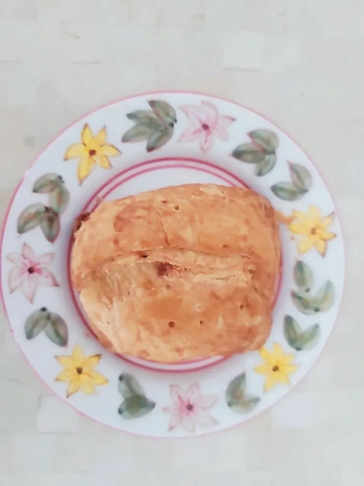 Apple pie split in half with a bite taken