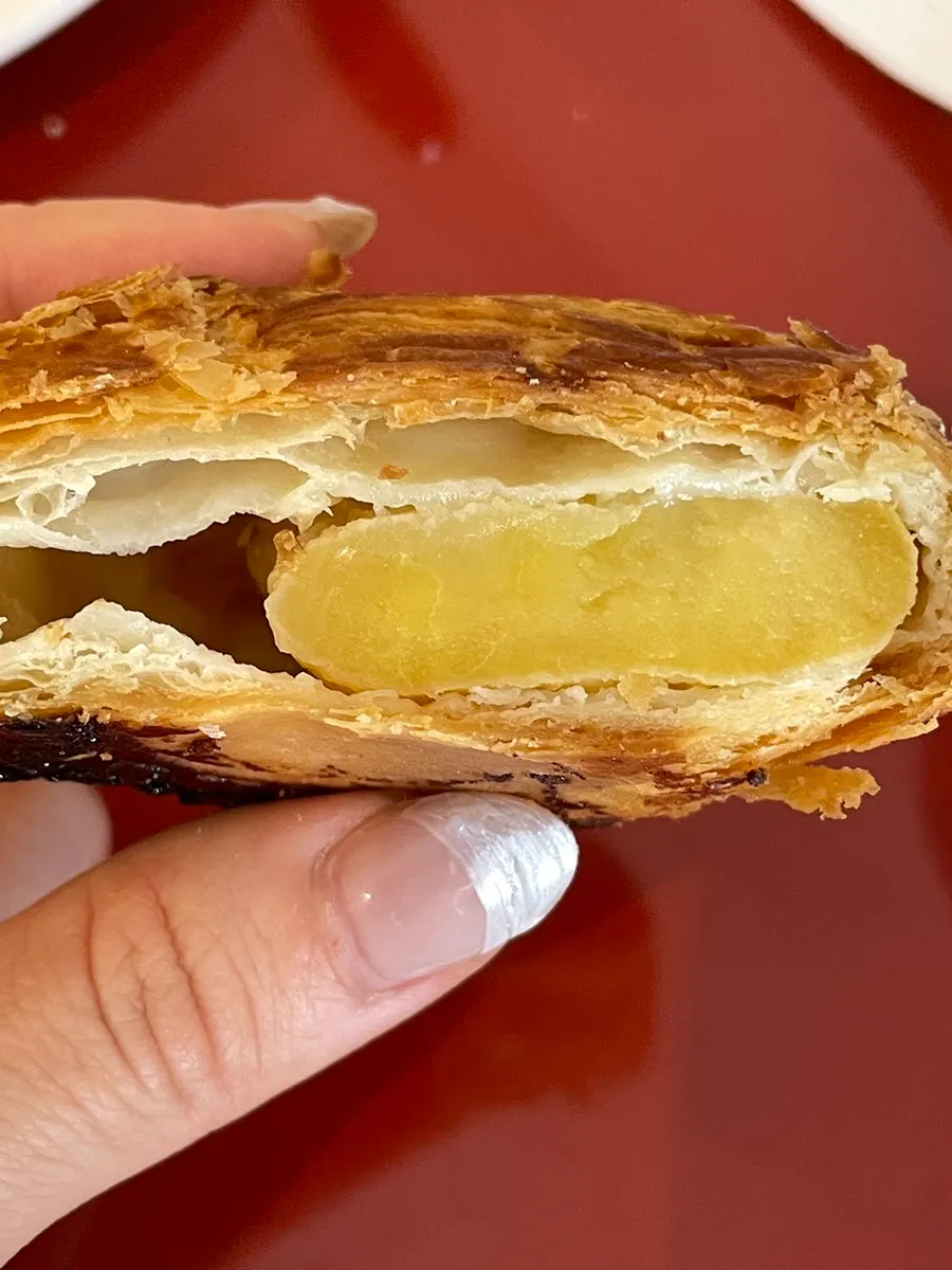 Holding and taking a bite of the Tokyo apple pie