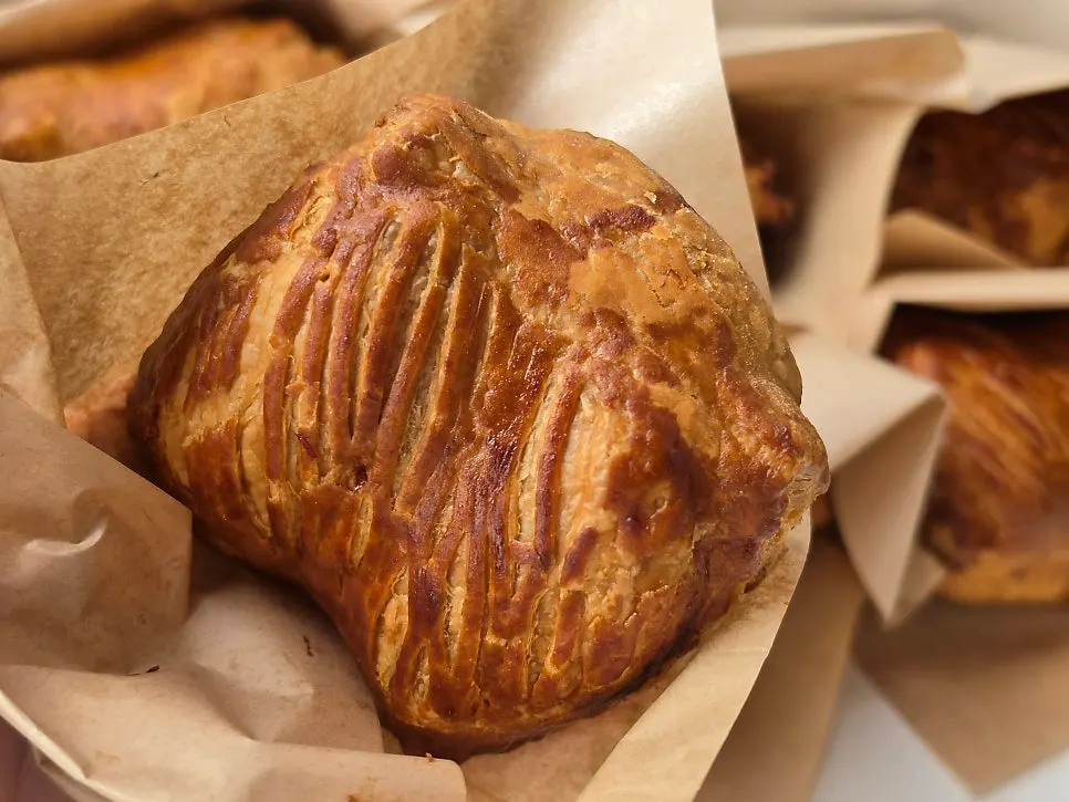 Palm-sized apple pie showing its pastry layers