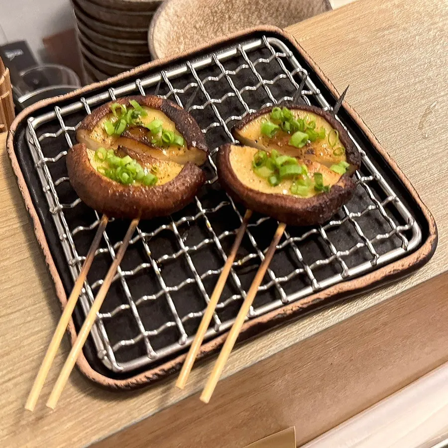 Chicken neck meat skewer topped with mustard seeds