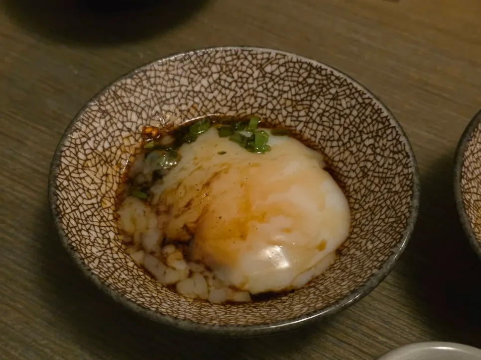 Tsukune patty dipped in poached egg sauce
