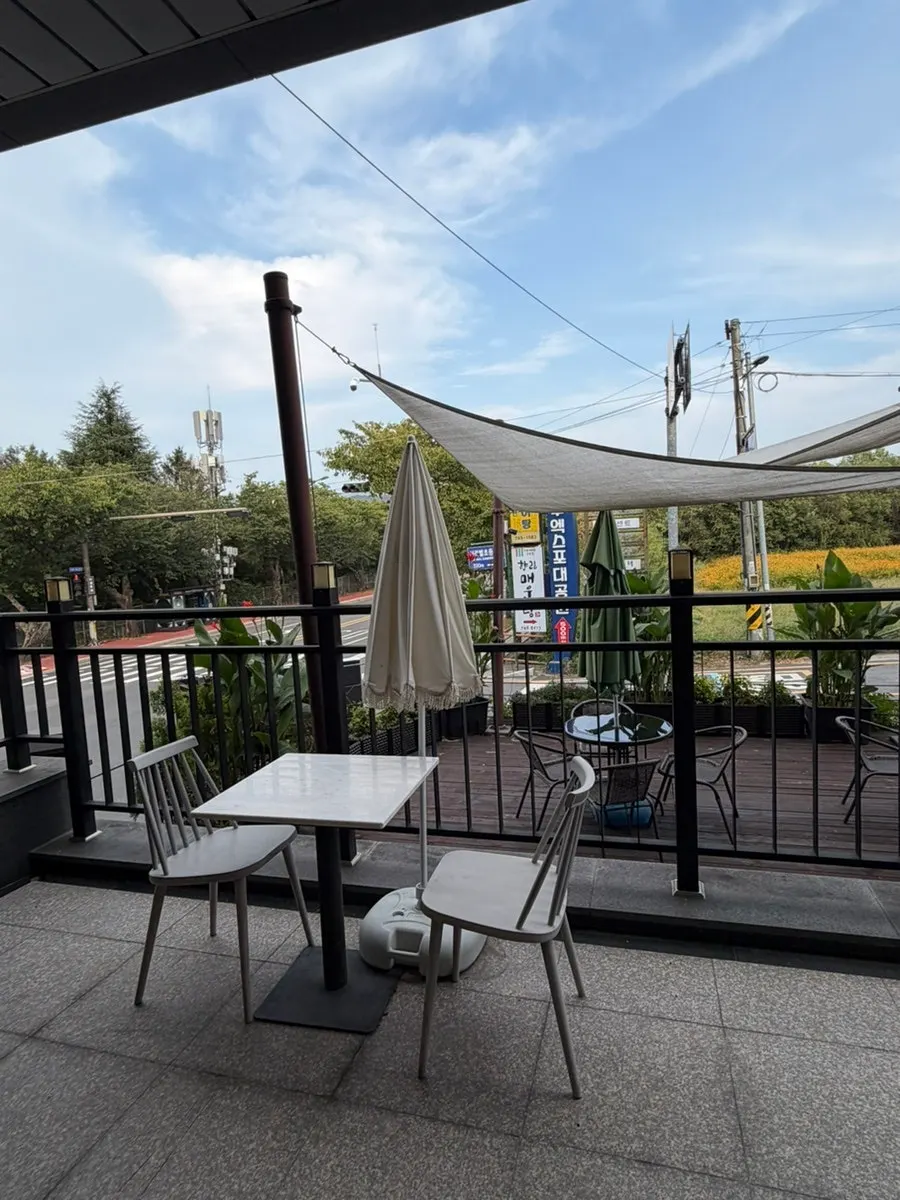 Outdoor terrace seating on the first floor of café Yard