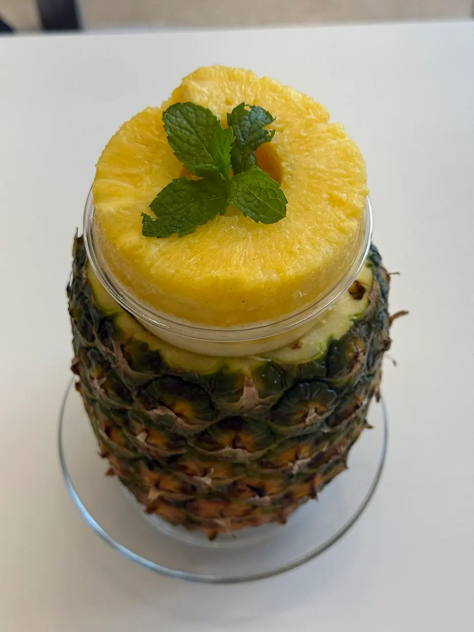 Whole pineapple smoothie in a large cup
