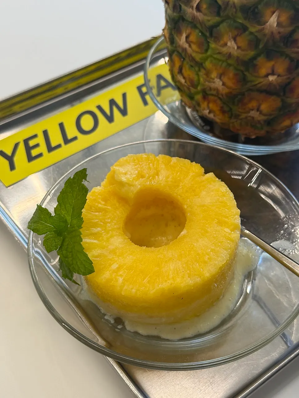 Three pieces of fresh pineapple served alongside the drink