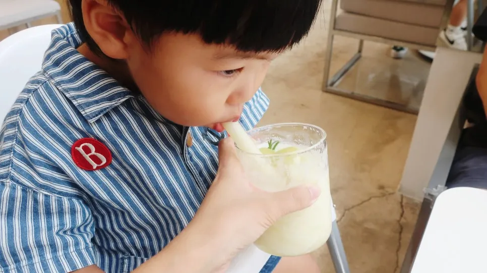 Table set up for drinking fresh fruit juice with a baby