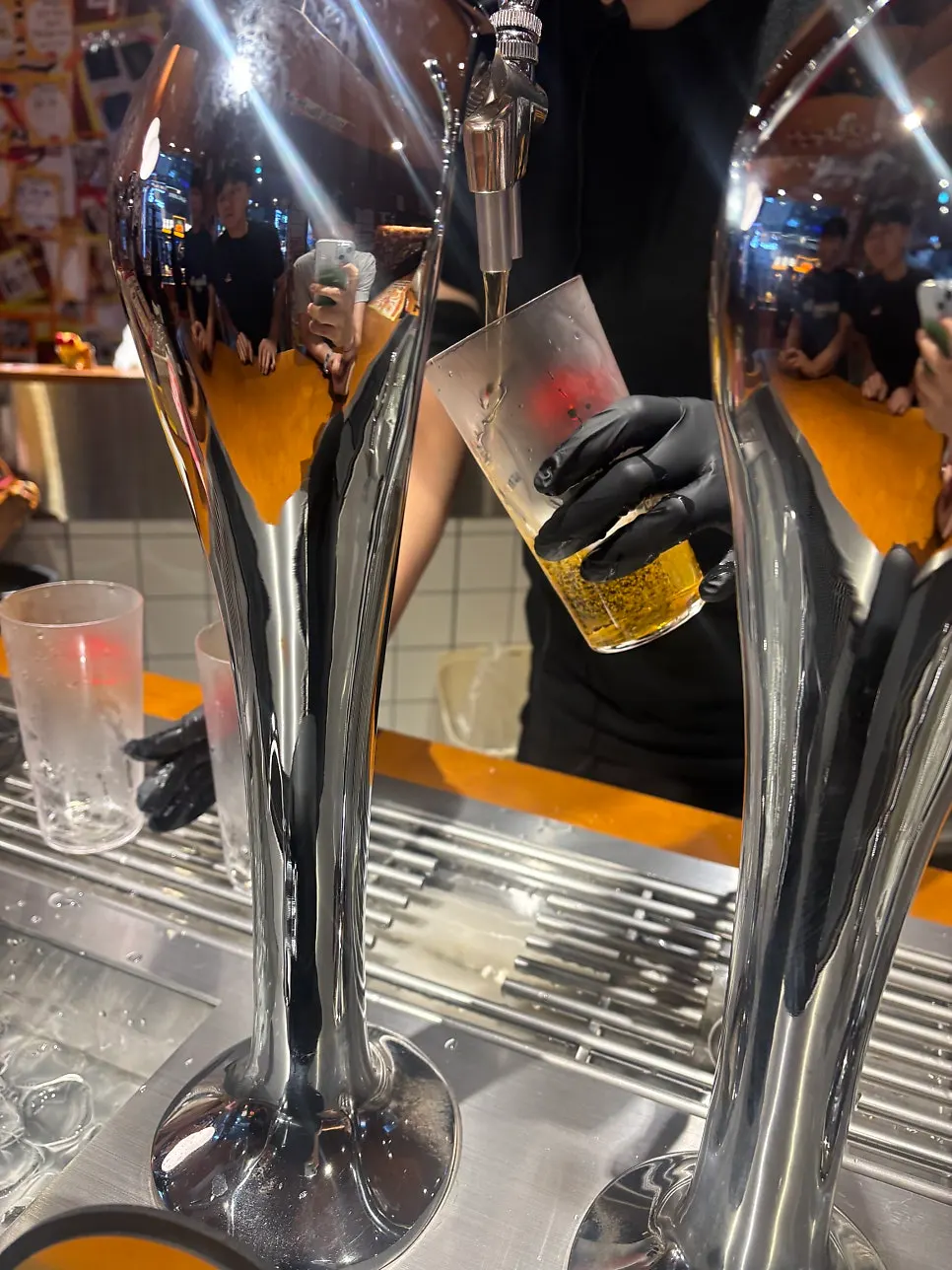 Thin glass with foamy draft beer on top
