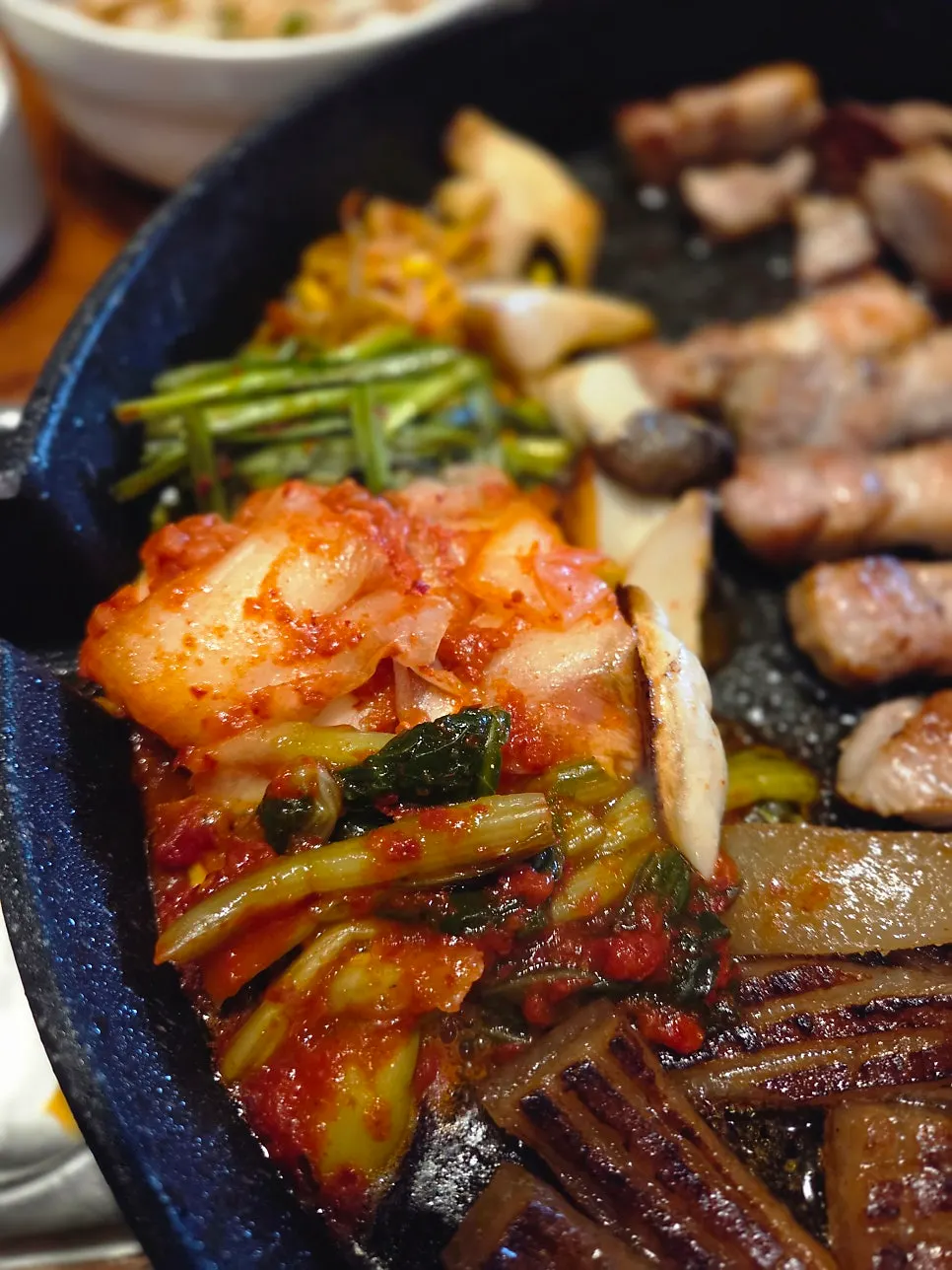 Meat and four kinds of kimchi on the grill plate