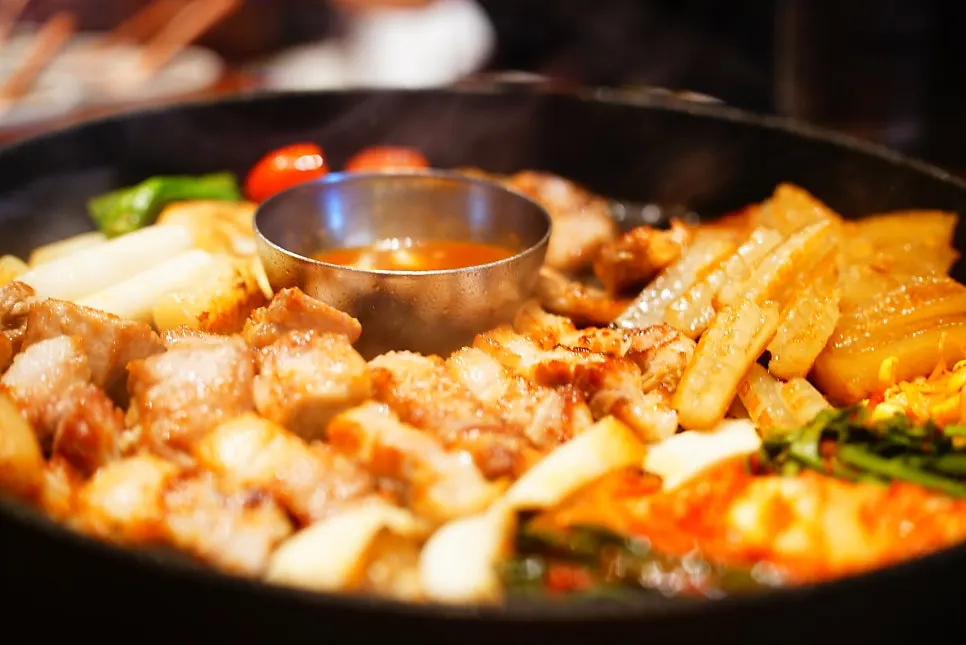Pork belly grilled and served by staff on the grill plate